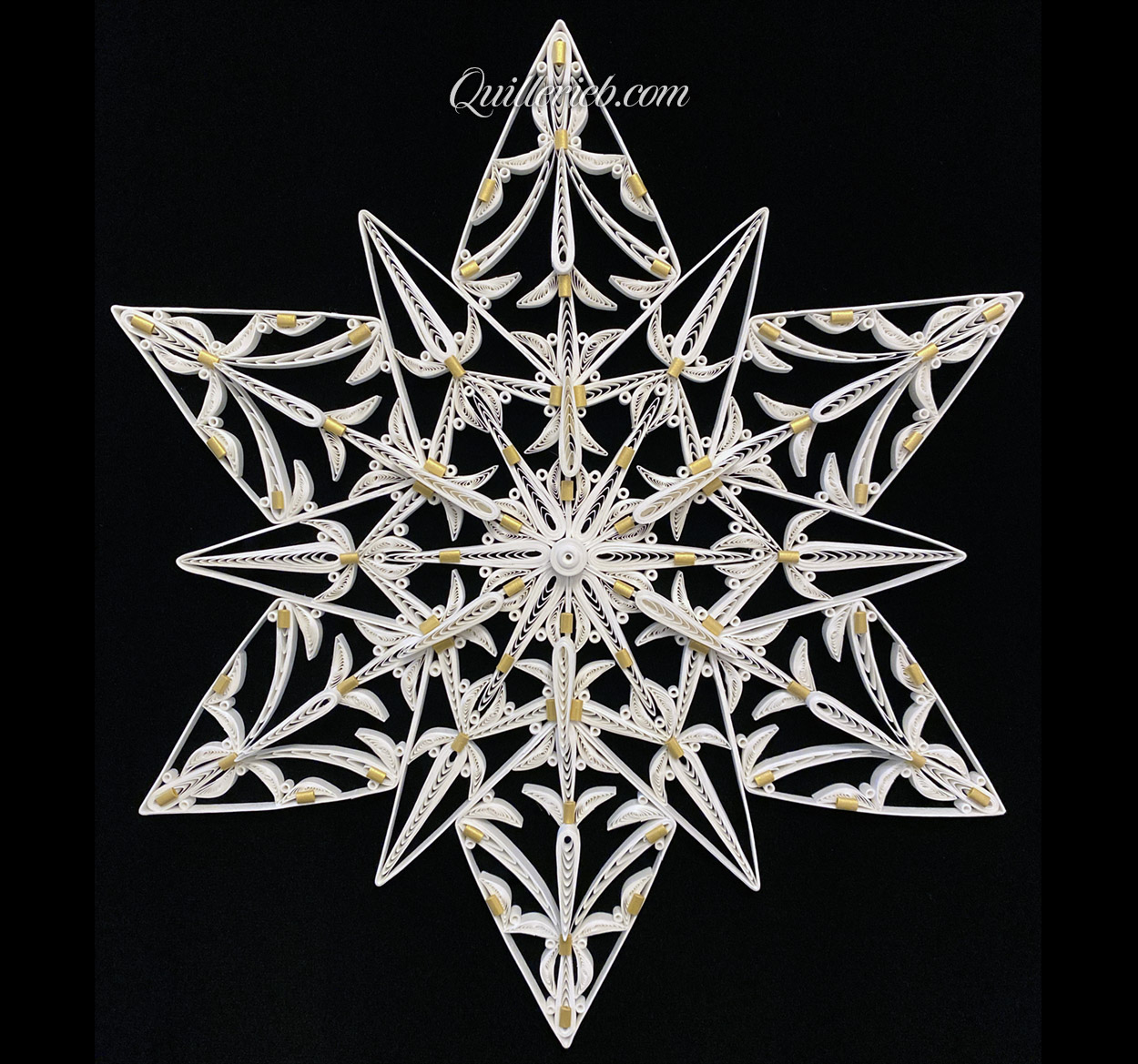 12-Point Star quilling design in white with touches of gold tones full view.