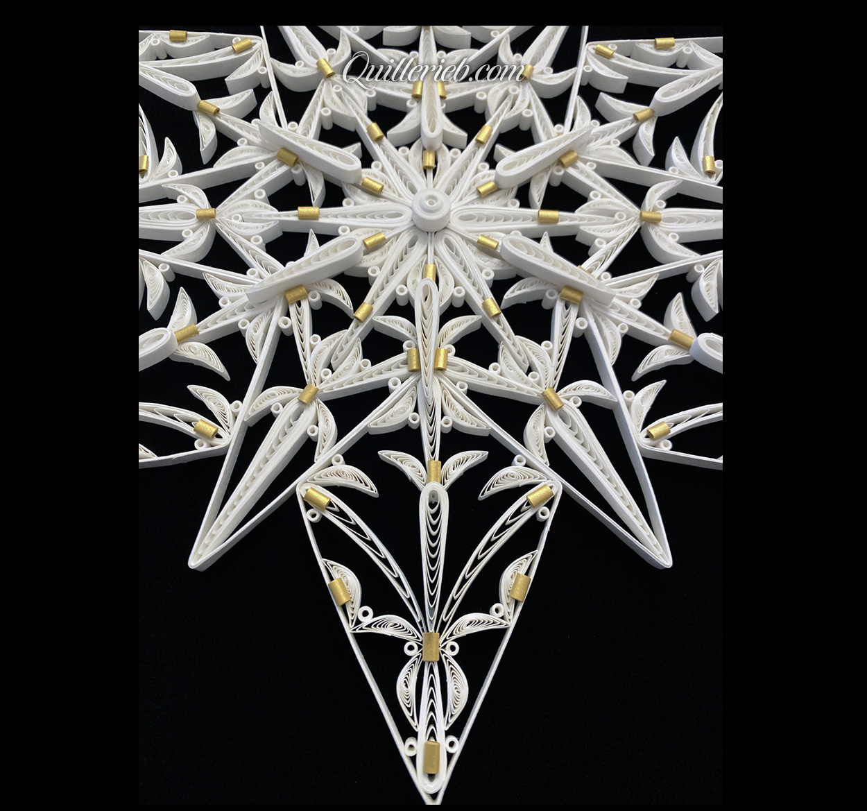 12-Point Star quilling design in white with touches of gold tones bottom close-up view.