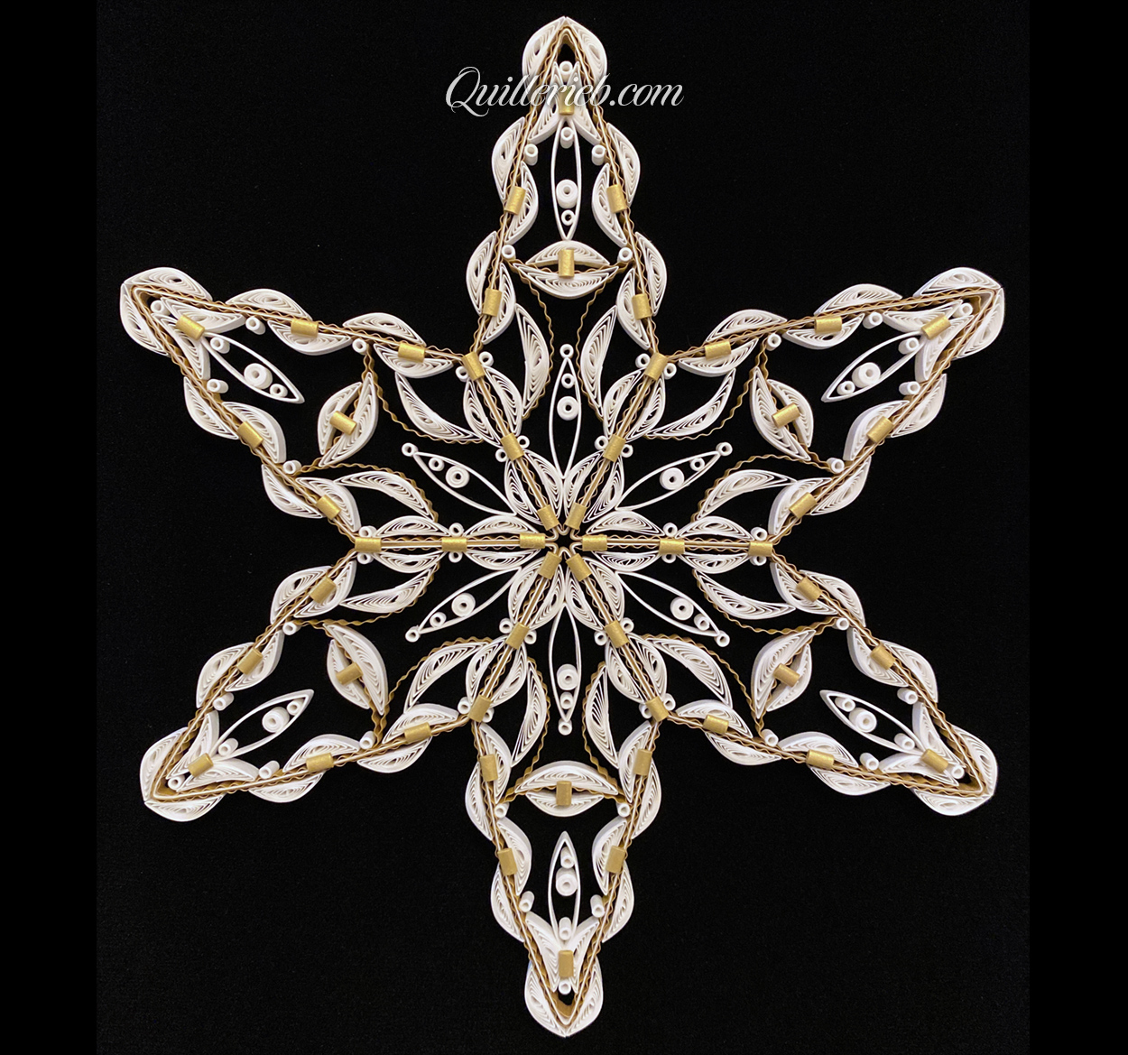 Rounded six-Point Star quilling design in white with elements of gold tones full view view.