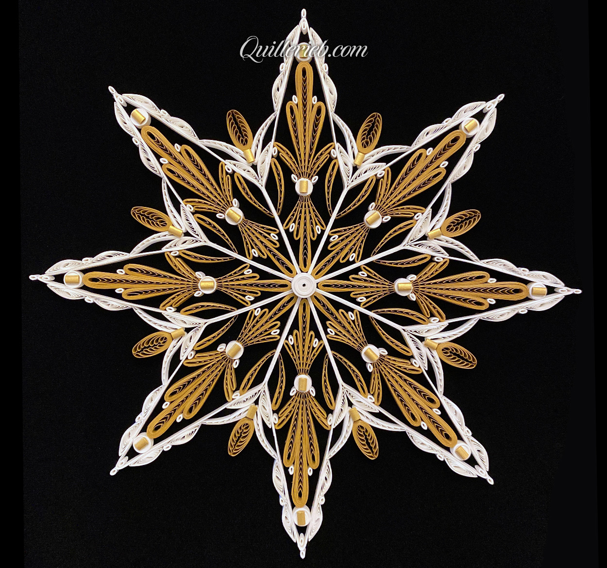 Eight-Point Star quilling design in brown tones and elements of white full view.